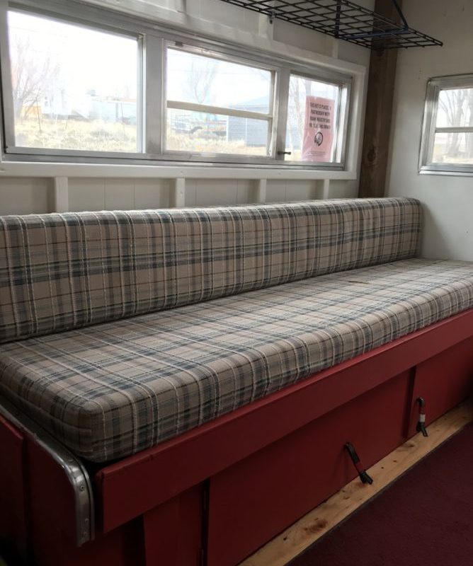 Bothy Wagon interior, bench that pulls out a converts to full bed.