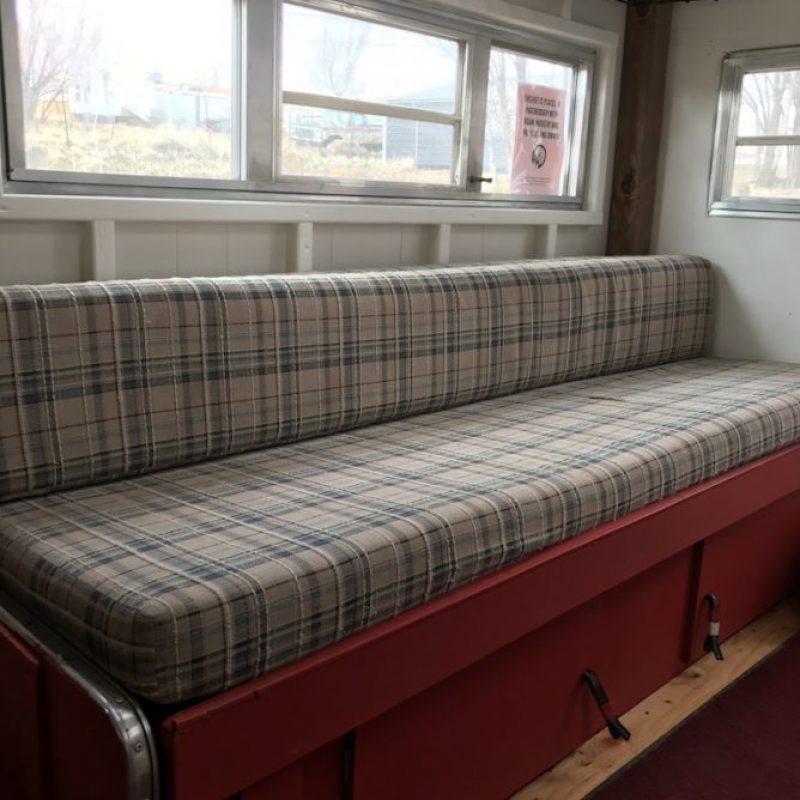Bothy Wagon interior, bench that pulls out a converts to full bed.